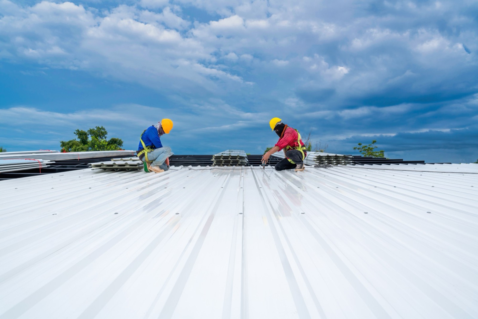 crew installing standing seam metal roof panels